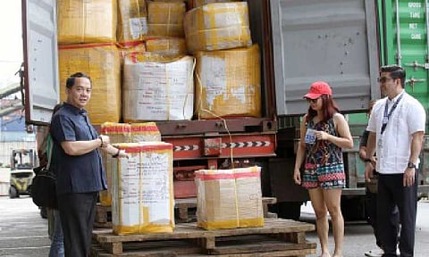 DELAYED NO MORE. Bureau of Customs Commissioner Ariel Nepomuceno (left) leads the inspection and distribution of the abandoned balikbayan boxes at a BOC facility in Port Area, Manila Thursday (Dec. 18, 2025). President Ferdinand R. Marcos Jr. earlier ordered the release of around 130,000 balikbayan boxes that were left unattended at the BOC. (PNA photo by Yancy Lim)