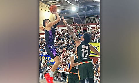 AIRBORNE ASSAULT. Mighty Warriors’ Raffy Celis (left) pulls up for a fadeaway jumper over the outstretched arm of Tiger Ship Builders’ Kent Ariar during their 2026 Cebu City Charter Day Cup elimination round encounter at the City Sports Institute. Celis chipped in 15 points to help the Warriors secure a narrow 82-80 victory. / 