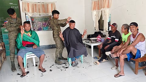 ILOILO. Soldiers of the 12th Infantry Battalion providing free haircut services during a community outreach program in Barangay Bayebaye, Jamindan, Capiz, as part of ongoing development and public service initiatives.