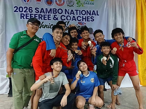 The De La Salle Sambo Team members and coach Samson Bernales celebrate their wins in the recently concluded  2026 Araw ng Dabaw Sambo National Open Championships.
