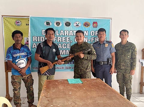 Saimbangon Village Chairperson Julambre Isnadi (2nd from left0 formally turns over one M1 Garand rifle to the 104th Infantry Battalion in the presence of policemen in the town of Pata, Sulu, on Saturday, April 11. 

