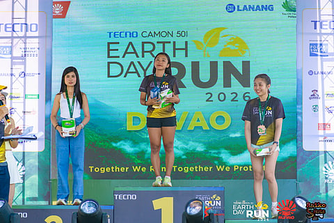 EARTH RUN DAVAO QUEEN. University of Mindanao’s Lyka Catubig, center, leads the top women’s 21K finishers in the Tecno Camon 50 Earth Day Run Davao 2026, Sunday, April 12, on an out-and-back course from SM Lanang parking grounds.