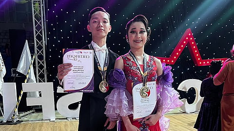 GOLDEN PAIR. Bhenz Rudolf Owen Semilla, left, and Francheska Dezzly Darvin of Davao City pose with their medals and certificates after winning two gold medals in the PDSF U21 Standard A and WDSF U21 Standard events during the World DanceSport Federation International Open and Philippine Superstars Open Dancesport Festival at Ninoy Aquino Stadium in Malate, Manila.