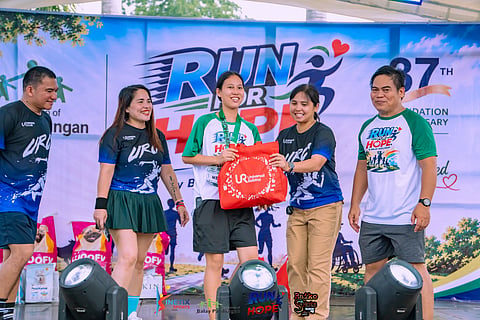 RUN FOR HOPE WINNER. A top finisher receives her prize during the Run for Hope 2026 charity fun run at Rancho Palos Verdes in Crocodile Park, Ma-a, Davao City on Saturday. The event, organized by Balay Pasilungan as part of its 37th foundation anniversary celebration, gathered hundreds of runners in support of vulnerable children.