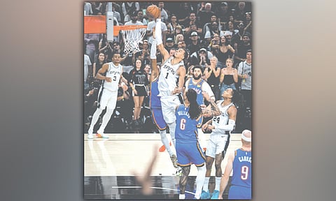 ALLEY-OOP. San Antonio Spurs center Victor Wembanyama (1) rises for an alley-oop dunk over Oklahoma City Thunder’s Shai Gilgeos-Alexander (partially hidden) during Game 4 of the Western Conference finals in San Antonio. Wembanyama led the Spurs with 33 points to help tie the series.  / 