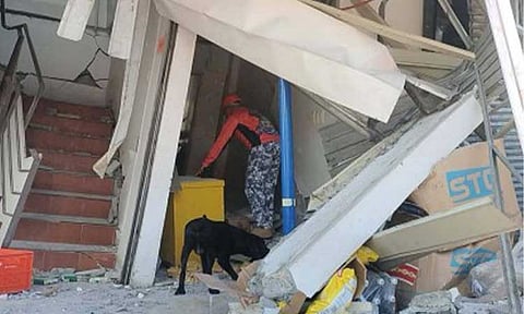 POST-QUAKE INSPECTION. A member of a specialized unit from the Philippine Coast Guard inspects a damaged commercial building in Barangay Calumpang, General Santos City, following the magnitude 7.8 earthquake that struck Sarangani province on Monday (June 8, 2026). Electricity in quake-affected areas of Mindanao is expected to be fully restored as early as Wednesday (June 10) through closer coordination among energy sector stakeholders, NEA Administrator Antonio Mariano Almeda said in an online briefing on Tuesday (June 9). (Photo courtesy of PCG)