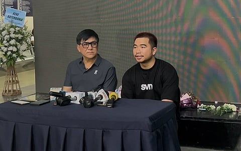Sports manager and agent Joevince Eusebio, right, and Ateneo de Davao University Blue Knights high school basketball coach Jess Linus Evangelio address the media during a press conference on the sidelines of Rene Clert "Bobet" Baterbonia's wake at the Ateneo de Davao University Senior High School campus in Bangkal, Davao City, on June 12, 2026.