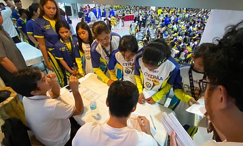 CEBU’S BEST. Student-athletes who won medals for Cebu Province in the 2026 Central Visayas Regional Athletic Association Meet and the Palarong Pambansa line up to receive their cash incentives from the Cebu Provincial Government at the Department of Education Ecotech Center.  / 