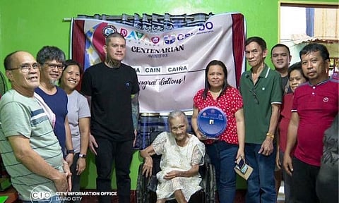 Davao City Mayor Sebastian "Baste" Duterte (fourth from left) and representatives from the City Social Welfare and Development Office (CSWDO) honor centenarian awardee Maria Caiña during a cash incentive and plaque presentation at her residence.