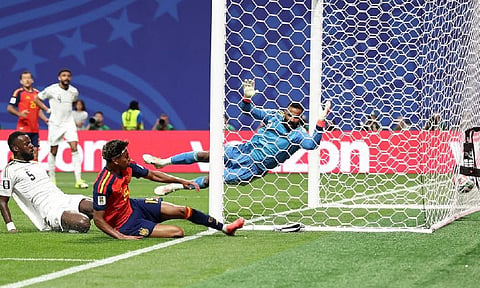 HISTORY MADE. Eighteen-year-old Spain forward Lamine Yamal (19) sends the ball into the net past Saudi Arabia goalkeeper Mohammed Al-Owais in the 10th minute for his first goal on his first World Cup start. Spain cruised to a 4-0 win in Group H action in Atlanta.  / 