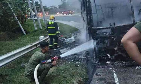 Troops from the Philippine Army’s 10th Infantry Division deploy fire hoses to help extinguish the fire that razed a passenger bus at Km. 67, in Barangay Tuboran, Mawab, Davao de Oro, on Monday, June 29, 2026. No casualties were reported in the incident. 
