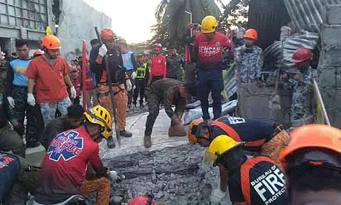 EMERGENCY RESPONSE. Search and rescue personnel from the Bureau of Fire Protection (BFP) and "Gensan Rescue" clear debris and search for survivors in General Santos City following the devastating magnitude 7.8 earthquake that struck Mindanao.