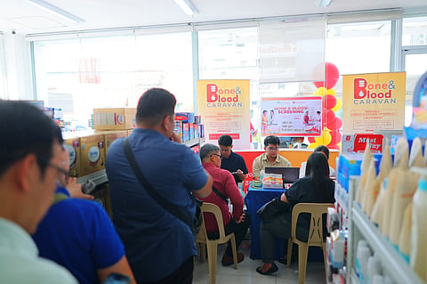 Mercury Drug customers line up inside the store for the free Bone and Blood Screening offered by Unilab, Inc.
