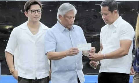 SCHOLARSHIP FUND. PAGCOR Chairperson and Chief Executive Officer Alejandro Tengco (center) turns over a PHP10-million check to Bulacan Governor Daniel Fernando (right) and Vice Governor Alexis Castro (left) for the first tranche of the Ayudang Hatid ay Tagumpay Scholarship Program at the Bulacan Capitol Gymnasium in Malolos City on Monday (July 6, 2026). The state gaming regulatory firm committed a total of PHP60 million to fund a scholarship program for 2,000 students in Bulacan. (Photo courtesy of PAGCOR)