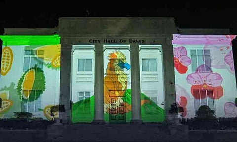 Visuals of a Philippine Eagle, native durian, and waling-waling orchids illuminate the facade of the Davao City Hall on August 11, 2026, during the annual Kadayawan Festival projection mapping show. The nightly event, running through August 31, transforms the local landmark into a multimedia display honoring the city’s abundance, agricultural heritage, and its 11 indigenous and Moro ethnolinguistic groups.