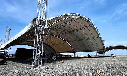 Workers assemble massive arched canopy tents and aluminum truss structures at Times Beach along the Davao City Coastal Road in preparation for the upcoming Indak-Indak sa Kadayawan grand showdown. The venue is being outfitted with shelter to accommodate thousands of spectators and performers expected at the cultural festival highlight on August 16