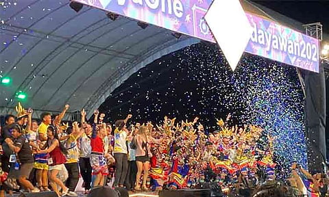 Members of the Balangay City High Performing Arts from Mati City, Davao Oriental celebrate on stage amidst falling confetti after being declared the Grand Champion of the Indak-Indak sa Kadayawan Open Category showdown along the Davao Coastal Road. The victory marks a historic three-peat grand slam championship streak for the group at the Mindanao-wide cultural festival.