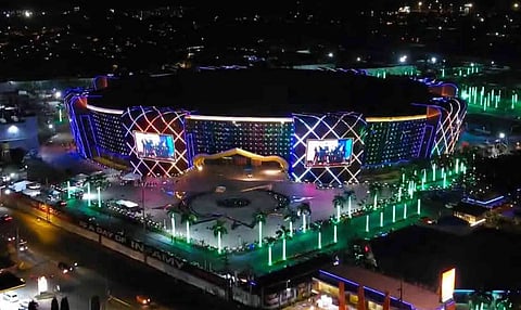  An aerial view shows the exterior of the newly constructed KJC King Dome illuminated at night along the Carlos P. Garcia Highway. Built by the Kingdom of Jesus Christ (KOJC) religious group, the megastructure is set to open to the public on September 1, 2026, following 14 years of construction that began in 2012. Boasting a seating capacity of 75,000, the multi-purpose indoor arena surpasses the 55,000-seat Philippine Arena in Bulacan to become the largest of its kind. According to project proponents, the facility is completely earthquake-resistant and engineered to withstand extremely high seismic activity.