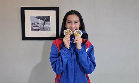 Filipino fencer Christine May Morales poses with her gold and silver medals after competing in the Southeast Asian Fencing Federation Junior and Cadet Championships in Kuala Lumpur, Malaysia. Morales, 13, won gold in the Under-14 Junior Women’s Foil and silver in the Cadet Women’s Team Foil. 