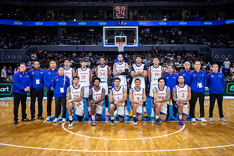 Gilas Pilipinas players and coaching staff pose for a team photo after their FIBA Basketball World Cup Asian Qualifiers game against Iran in Manila. The Philippines swept the fourth qualifying window with wins over Iran and Jordan.
