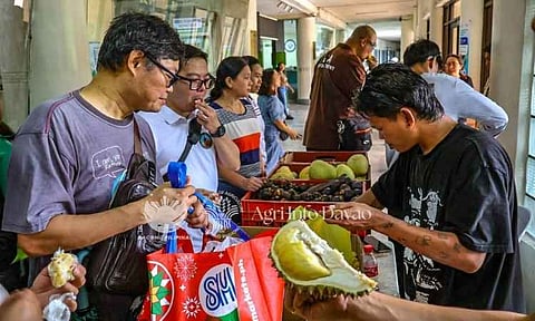 Consumers sample and purchase fresh durian and other native fruits shipped from Mindanao during the Department of Agriculture’s Kadiwa on Wheels fruit festival held at the DA Central Office. Organized by DA-Davao to expand domestic markets and increase per capita consumption, the direct-to-consumer caravan features durian, mangosteen, and pomelo sourced from farms in Davao City's Calinan and Baguio Districts. Following its initial stops in Metro Manila, the 70-metric-ton market initiative is scheduled to bring the regional produce to Cebu City, Baguio City, and Pasay City through October to secure wider market access for local fruit growers. 