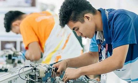 Two participants focus closely on assembling and troubleshooting complex industrial automation and mechatronics machinery. The event, aligned with initiatives driven by the Technical Education and Skills Development Authority (TESDA), highlights the country's ongoing efforts to enhance vocational training and prepare its workforce for high-demand, tech-driven industries.
