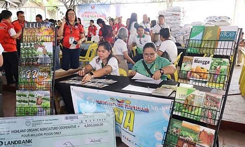 Representatives from the Department of Agriculture Regional Field Office XI present a symbolic check worth 4,000,000 PHP to the Highland Organic Agriculture Cooperative during an agricultural caravan and service fair. The funding aims to boost local organic farming initiatives and support cooperative development across the Davao region.