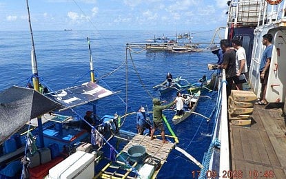 BFAR personnel aboard the fuel subsidy mission distribute assistance to Filipino fisherfolk in the West Philippine Sea