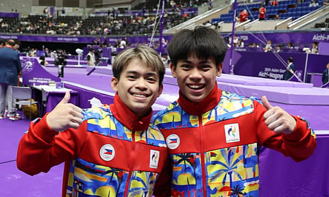 YULO BROTHERS ADVANCE. Carlos Yulo, left, and Karl Eldrew Yulo compete in the men’s artistic gymnastics qualifiers at the 20th Asian Games in Nagoya, Japan. Carlos advanced to the floor exercise, parallel bars and vault finals, while Eldrew secured spots in the floor exercise and horizontal bar finals. 
