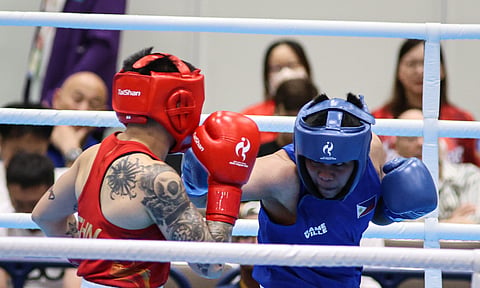 IN THE RING. A Filipino boxer trades punches with China’s Yang Chengyu during their women’s 60-kilogram quarterfinal bout at the Aichi-Nagoya 2026 Asian Games in Nishio, Japan, on Monday, Sept. 28, 2026. The Filipino boxer lost by unanimous decision, ending her bid for an Asian Games medal. 
