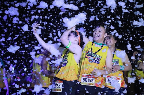 FOAM PARTY. Runners celebrate after completing the first Tagum Tourism Sunset Run on Saturday, Sept. 26, 2026, at the City Hall Grounds in Tagum City, Davao del Norte. Around 1,600 runners joined the 5K and 10K categories despite the rain before taking part in a foam party that capped the event. 