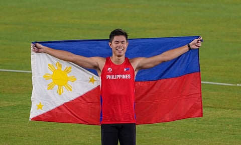 GOLDEN MOMENT. Philippine pole vaulter EJ Obiena celebrates with the Philippine flag after winning the men’s pole vault gold medal at the 2026 Asian Games on Tuesday, Sept. 29, 2026, at Mizuho Park Athletic Stadium in Nagoya, Japan. Obiena cleared 5.91 meters to defend his title and break his own Asian Games record. 