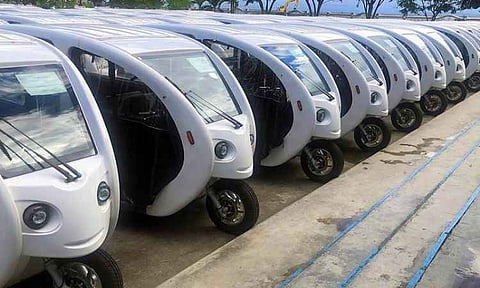 A fleet of newly manufactured electric tricycles (e-trikes) is lined up during a deployment turnover by the Department of Energy (DOE). The battery-powered, zero-emission vehicles are part of a government initiative to modernize public transport, reduce carbon emissions, and phase out traditional gasoline-powered tricycles across local government units.