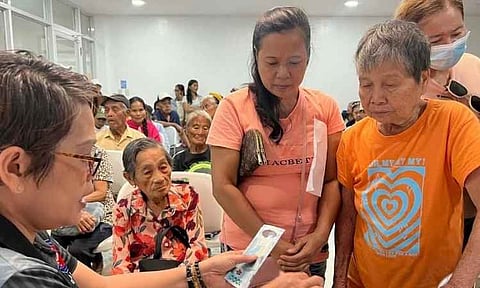 Representatives from the National Commission of Senior Citizens (NCSC) distribute cash assistance to elderly beneficiaries during a localized payout event in Kapalong, Davao del Norte. Under the Expanded Centenarians Act (Republic Act 11982), qualified Filipino senior citizens reaching milestone ages of 80, 85, 90, and 95 receive a lump-sum cash gift of ₱10,000, while those reaching 100 receive ₱100,000 as part of the national government's social optimization program.