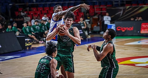 DEFENSE. Gei Chiu (center) of the Terrafirma Dyip secures the rebound in their game against the NLEX Road Warriors last August in the Philippine Basketball Association Season 50 Governor’s Cup. / PBA IMAGES