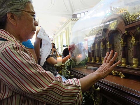 Relic visit. Josefina Lumapas, a St. Therese devotee, prays to the saint to help her see again as she has been suffering from cataract. The relic of St. Therese was at the National Shrine of Saint Joseph Parish in Mandaue City before it was brought to the headquarters of the Central Command in Cebu City. (SunStar Foto/Allan Cuizon)