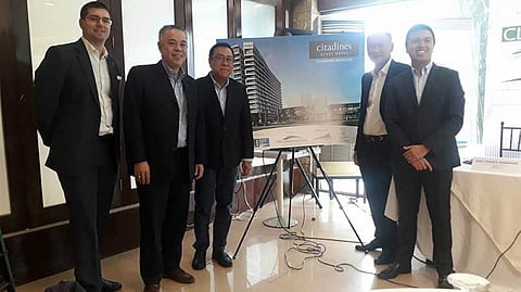 BACOLOD. Cebu Landmasters Inc. President Jose Soberano III (center) and Executive Vice President and Chief Operating Officer Jose Franco Soberano (right), Capitaine Inc. President Alec Lustre (second from right), and The Ascott Limited Regional General Manager for the Philippines and Thailand Arthur Gindap (second from left) and Area General Manager for Philippines Cluster Philip Barnes (left) unveil the perspective of Citadines Bacolod during the service management agreement signing at 21 Bar and Restaurant in Bacolod City yesterday, June 19. (Erwin P. Nicavera)