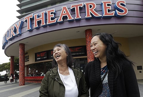 In this Thursday, August 23, 2018 photo, Alice Sue, left, and her daughter Audrey Sue-Matsumoto laugh while interviewed after watching the movie Crazy Rich Asians in Daly City, California It was Sue's second time watching the movie. When "Crazy Rich Asians" surpassed expectations and grabbed the top spot in its opening weekend, the film also pulled off another surprising feat. It put Asians of a certain age in theater seats. (AP Photo)