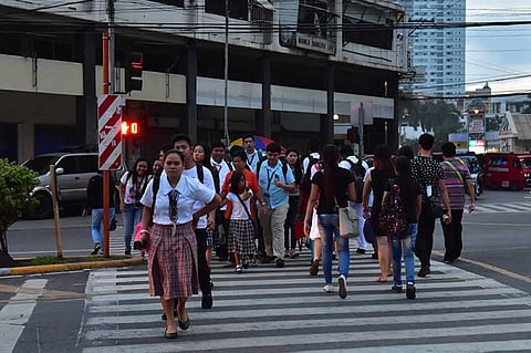 DAVAO. Students and workers follow the traffic rules in crossing the street along Magsaysay Avenue, Davao City. (Photo by Mark Perandos)
