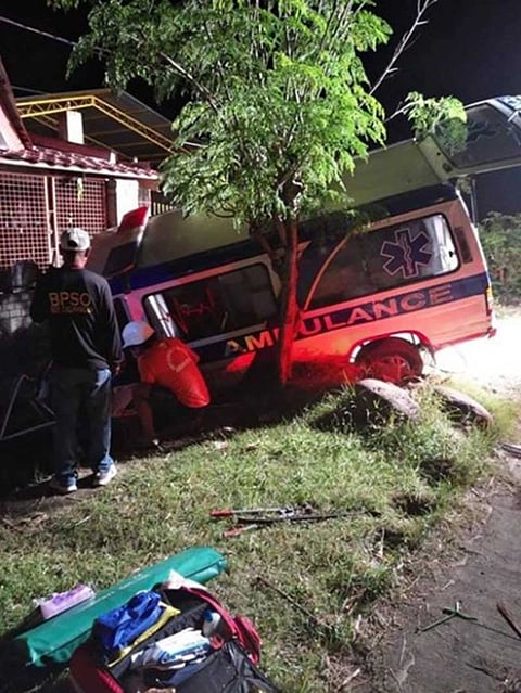 NEGROS OCCIDENTAL. Rescuers pull out the driver who was stuck on the driver's seat after the ambulance hit a dump truck and fell on the canal in Bago City, Negros Occidental early Friday. (Photo contributed Bago City Police) 