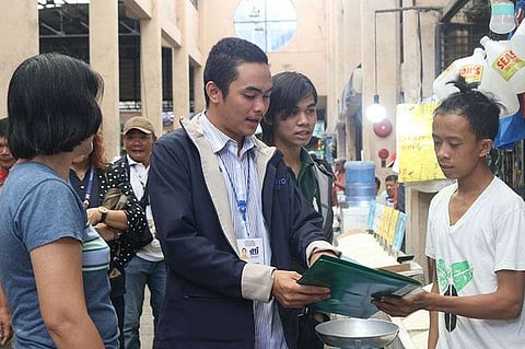 Kher Jake Martin Trayco (center) of the Department of Trade and Industry along with other members of the Local Price Coordinating Council checks the SRP compliance of rice retail outlets at the public market of Bago City. (Contributed Photo)