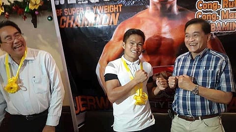 CAGAYAN DE ORO. Jerwin Ancajas gamely gestures in a fighting stance with Rep. Maxie Rodriguez as the latter's brother Rufus gleefully cheers from the other side on Saturday's (Dec. 8) lunch forum with the Cagayan de Oro press. (Lynde Salgados)