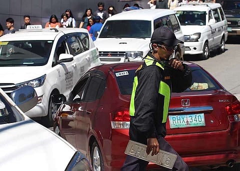 BAGUIO. A traffic enforcer work on the clock in Baguio City as congestion worsens during long weekends and holidays. A city official is eyeing the transfer of bus terminal outside the central business district to decongest the city. (Jean Nicole Cortes)