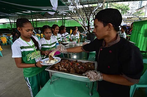 DAVAO. Athletes line up for their meals.
