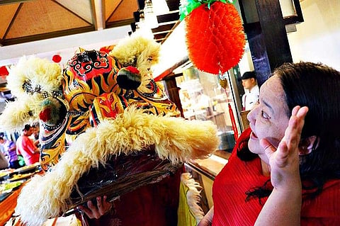 DAVAO. Edith Regalado greets Lion dance performer for good luck. (Joji Alcantara)