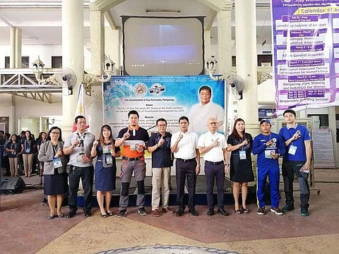 City of San Fernando Mayor Edwin Santiago, Vice-Mayor Jimmy Lazatin, City Administrator Fernando Limbitco, City Human Resource Management Officer Rachelle Yusi, and City Health Officer Eloisa Aquino together with prepaid plan medical health card awardees flash the "Fernandino First" sign at the city hall on Monday, March 11, 2019. (Photo by Nicole Renee David)