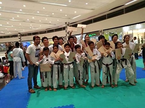 The Black belters of Hanah Taekwondo with Coach Vic Feria, with from left first row: Zach Olivo, Auster Joseph Burata, Hans Samodio, Adrian Galinea, Ethan Chavez, Zane Olivo, Thea Galila; and 2nd row: Coach Vic Feria, Eiran Sumaria, Lester Escasinas, Christian Monasque, Davon Pecha, Al Frances Reyes, Mary Angeline  Alcantara, Joshua Emmanuel Deita, Ashley Chavez, and Nea Aplasca. (Contributed Photo)