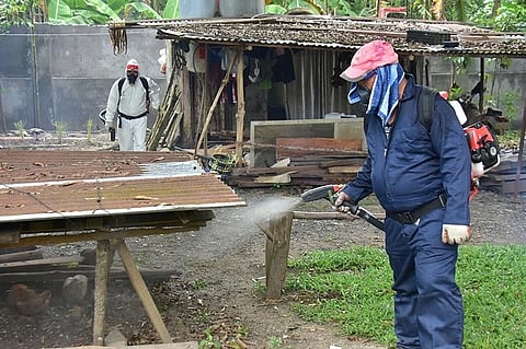 DAVAO. Personnel from the Davao City Health Office Tropical Disease Prevention and Control Division sprayed hard-to-reach areas in houses in Purok 1, Barangay Mahayag, Bunawan, Davao City.