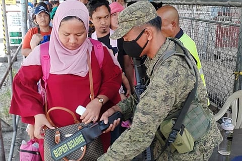 ZAMBOANGA. A soldier assigned with the Task Force Zamboanga conducts thorough inspection Friday, October 18, of all inbound passengers at the port of Zamboanga as security has been tightened amid threats from lawless groups, including the Abu Sayyaf. (SunStar Zamboanga)