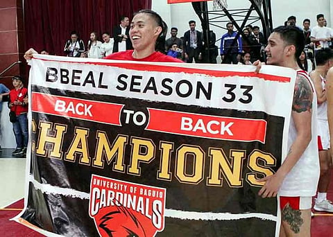 WOOED. University of Baguio Cardinals Efren dela Cruz lifts the championship banner after toppling University of the Cordilleras Jaguars in their championship match. Dela Cruz, together with four other Cardinals are reportedly being wooed to play in Manila. (Photo by Jean Nicole Cortes)